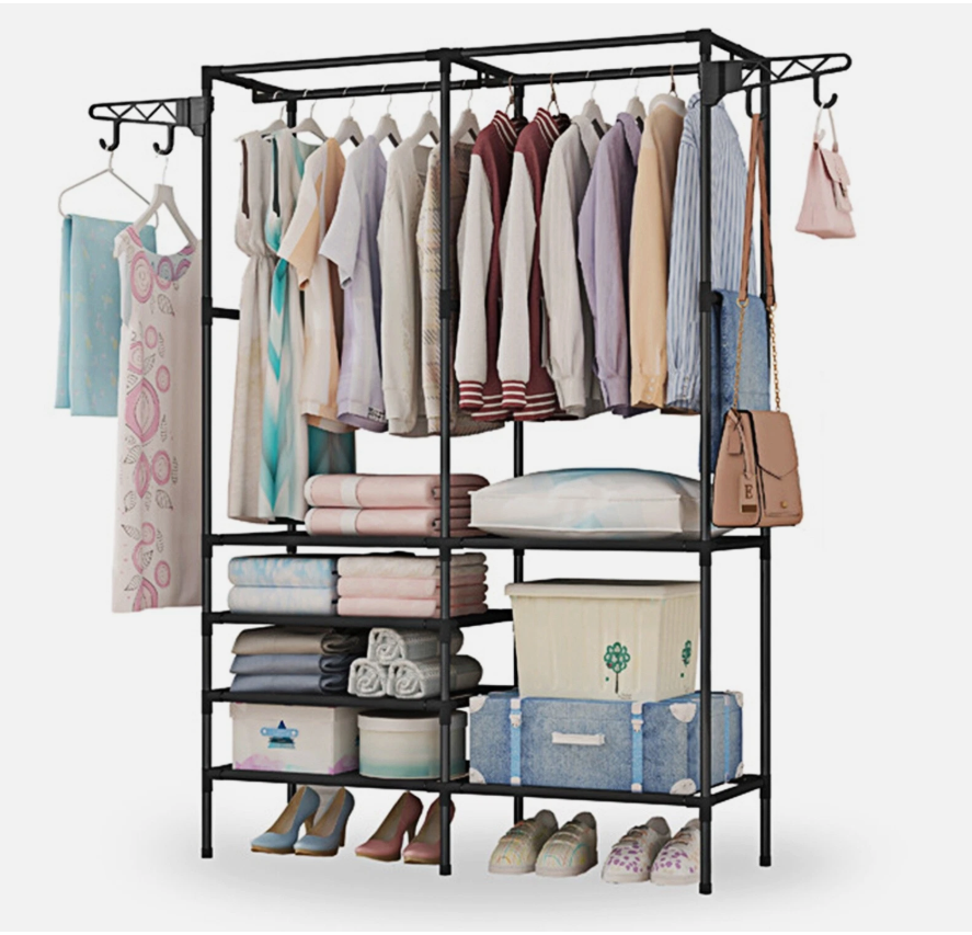 Black freestanding clothes rack with hanging shirts and jackets, folded items and storage bins on shelves, plus shoes at the base.