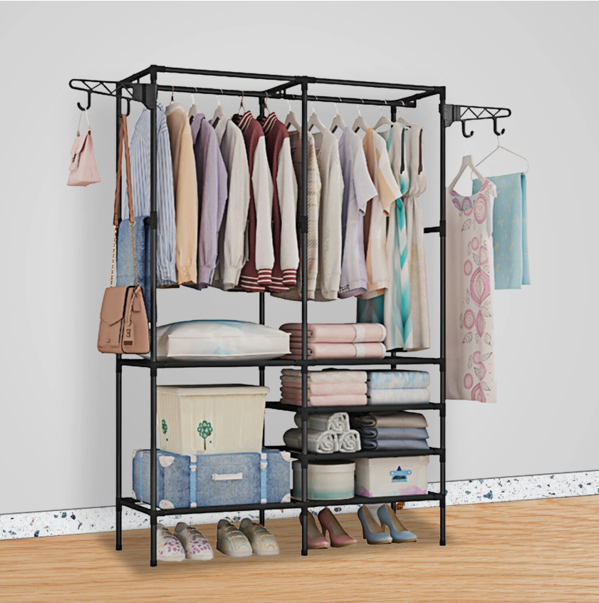 Metal freestanding closet rack with hanging shirts, folded blankets, and labeled storage boxes on shelves, plus shoes at the base.