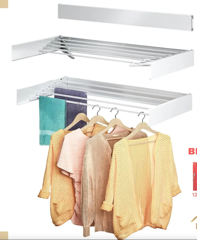 White multi‑tier closet organizer with hanging rails and shelves, displaying pastel sweaters and towels for scale and use.