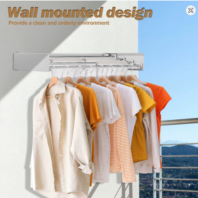 Wall-mounted clothes rail with a row of shirts on wooden hangers, mounted to a white wall on a sunny balcony with a city view in the distance.